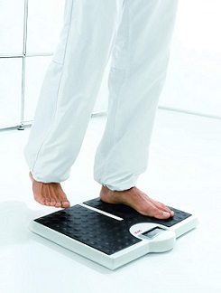 Image of a user stepping onto the scale in bare feet.