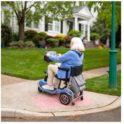 Woman Driving Scooter Up Slight Incline