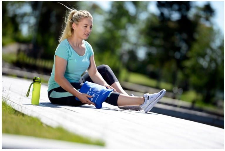 Woman Sitting Outside With Soft Pack on Her Knee