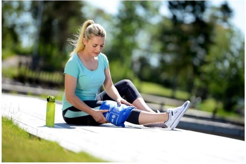 Woman Sitting Outside With Soft Pack on Her Shin