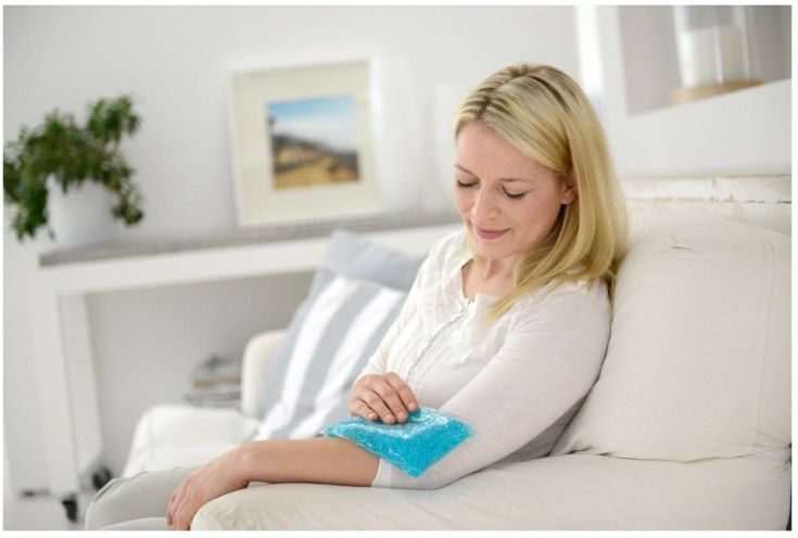 Woman Sitting on a Couch With Sports Pack on Elbow