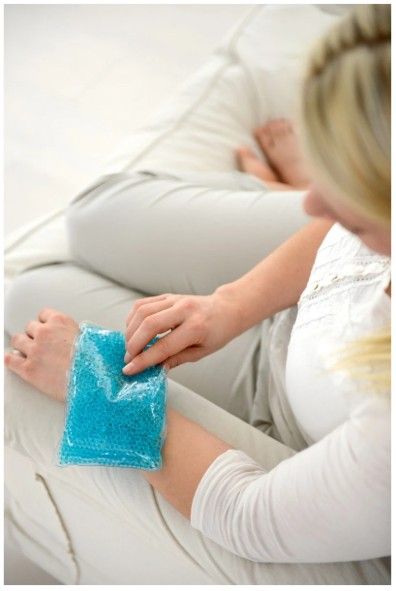 Woman Sitting on a Couch Holding Sports Pack on Her Wrist