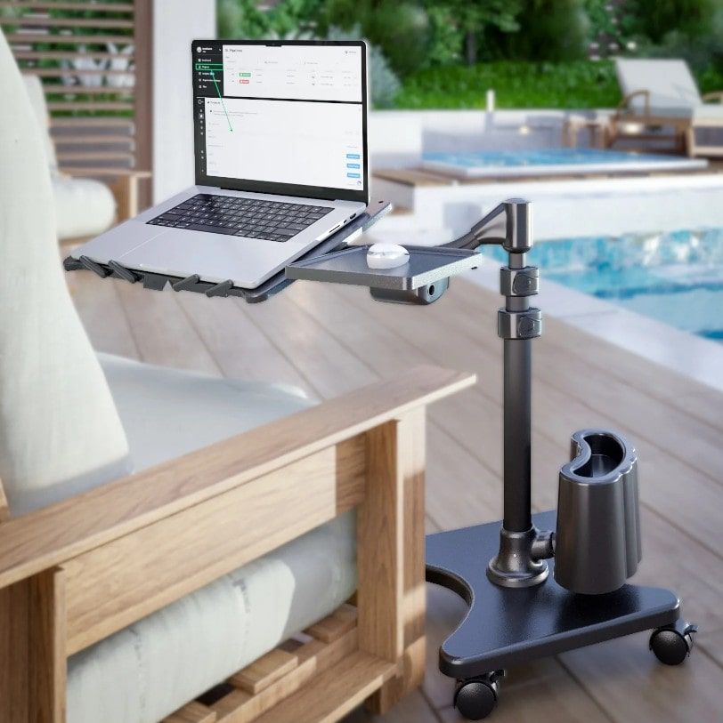 Black Laptop Stand on Pool Deck Beside White Chair