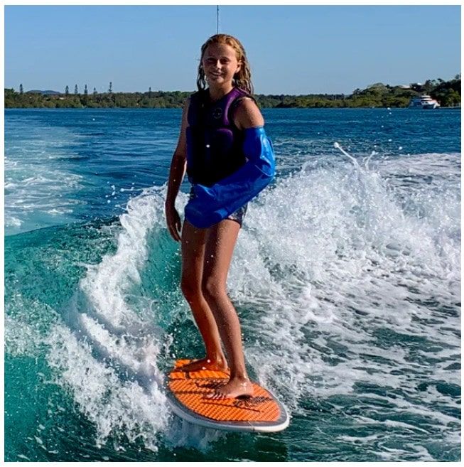 Girl Surfing While Wearing Cast Cover