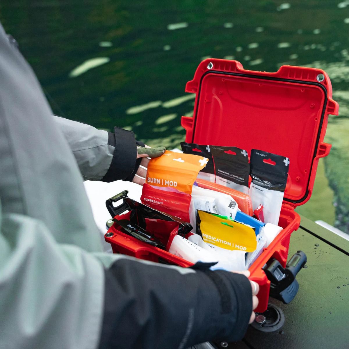A boater opens the Boat Medic First Aid Kit and selects the Burn Mod package from inside