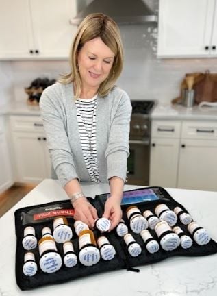 Woman storing pill bottle in Razbag