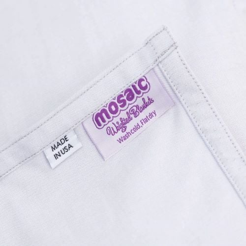The Lap Pad's tag: Mosaic Weighted Blankets. Wash cold, flat dry. Made in USA.