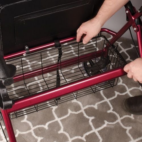 The rollator features a basket beneath the seat to hold personal items.