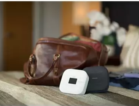 CPAP device with case next to a carry-on bag