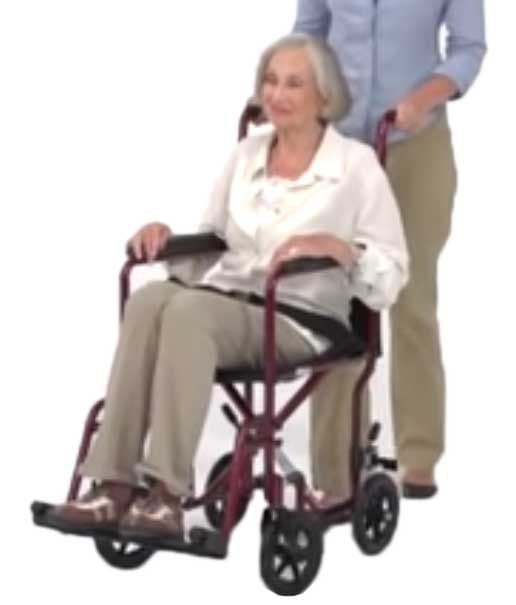 A caregiver pushes a woman in the transport chair