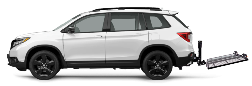 The EZ Carrier mounted and unfolded on the back of a white station wagon.