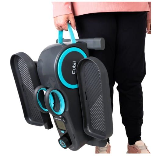 Woman carrying Cubii Total Body Elliptical