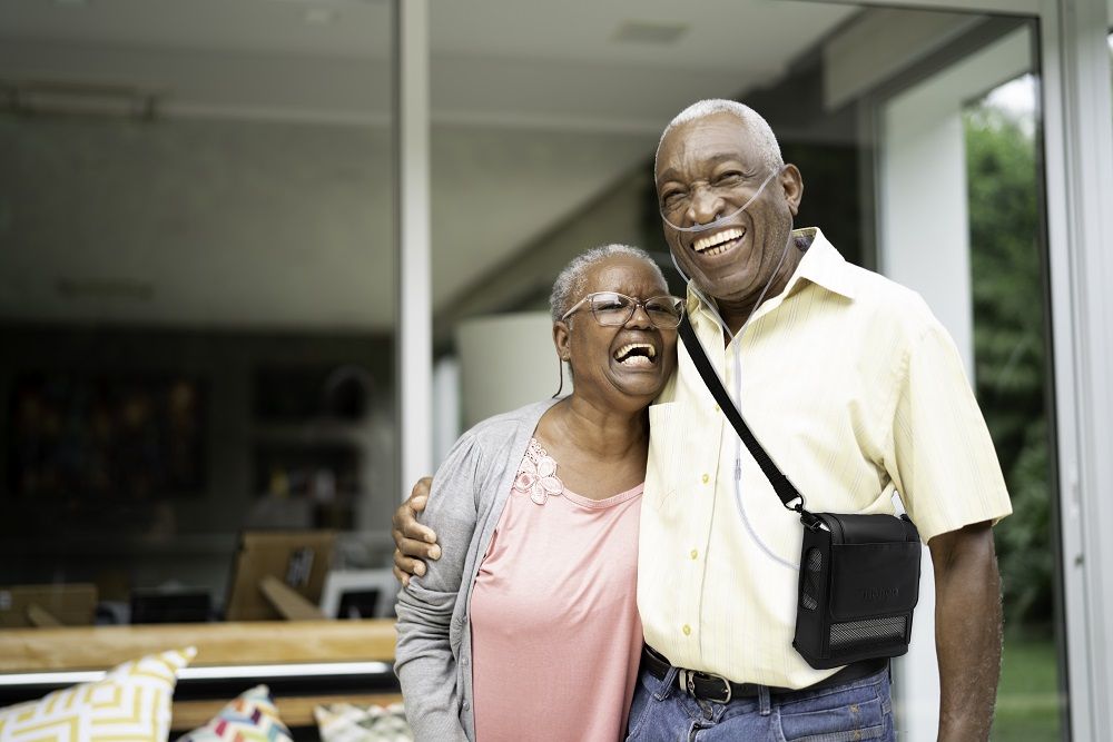Couple with Man Strapped with the G5 in an Inogen Carry Bag