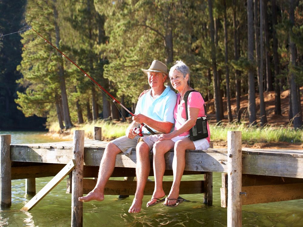 Lifestyle photo of a couple fishing at the pier with the woman with the G5 inside carry bag