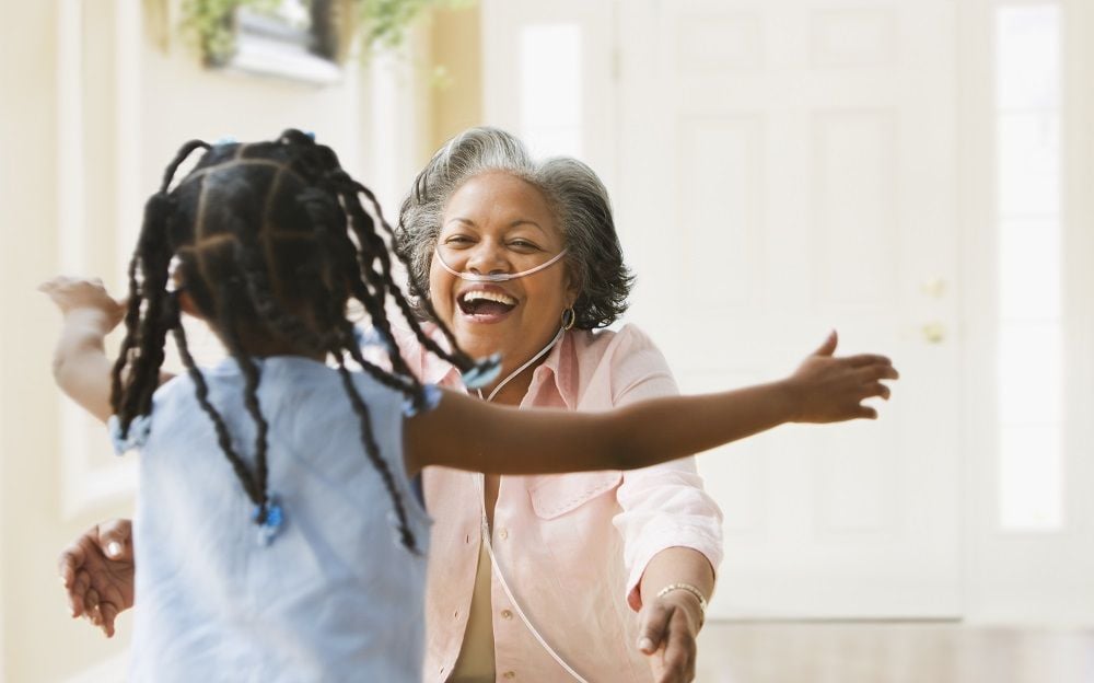 This lifestyle photo is of a grandma wearing her G5 unit to have her hands free to hug her grandchild.