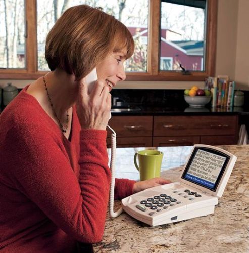 Hamilton Captel 840i Captioned Telephone use by a woman.