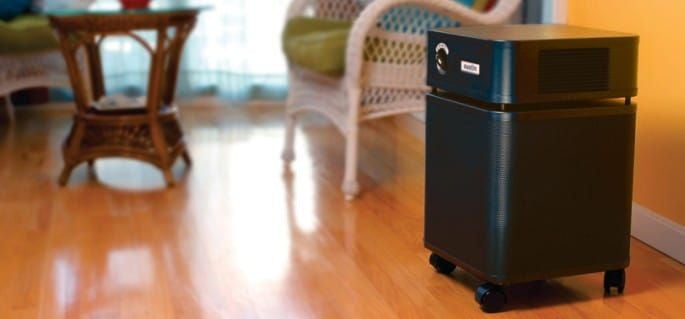 Black Air Filter in Room With Wood Floors and Wicker Furniture
