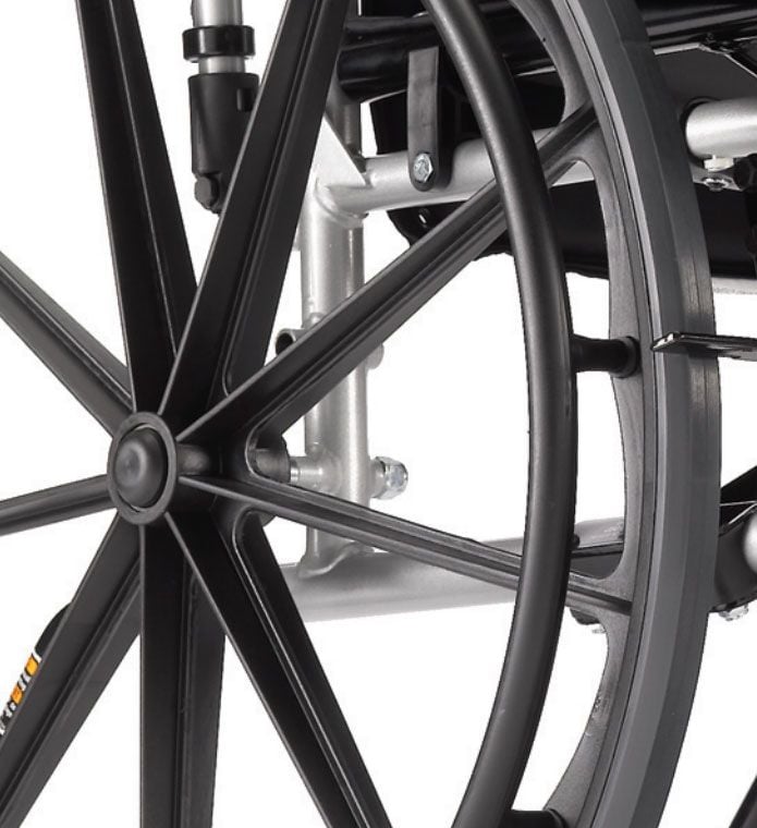 Close up view of rear wheel, detailing the wheels spokes and axle assembly