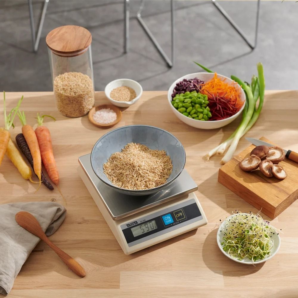 TANITA general scale on kitchen counter with various foods