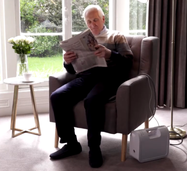 Man Reading the Paper on a Chair With the Mangar Raiser