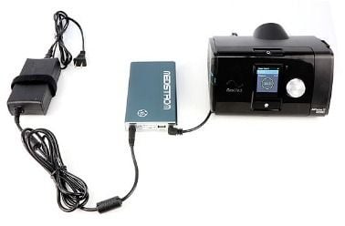 Battery with a cable and machine plugged in