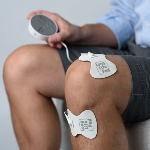 Man attaches TENS pads to his legs