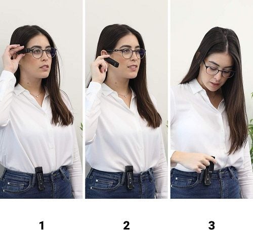 A woman demonstrating how the OrCam MyEye attaches to the OrCam MyCharger.
