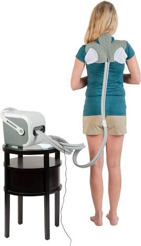 Woman uses the universal pad on her upper back