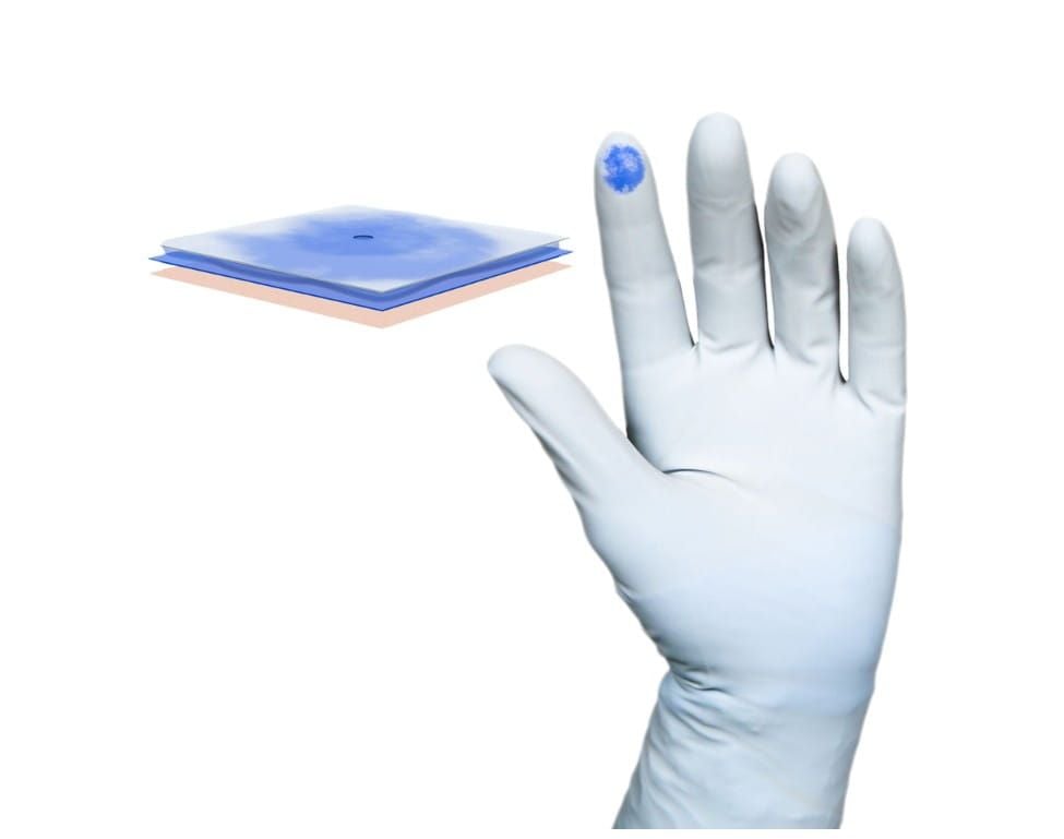 Gloves With a Blue Dot on the Index Finger and Blue Square Cross-Section of Glove Demonstrating Perforation Detection Technology