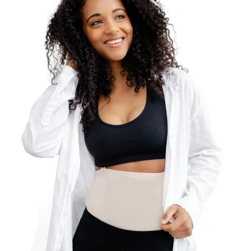 Woman wearing the postpartum recovery garment underneath clothes.