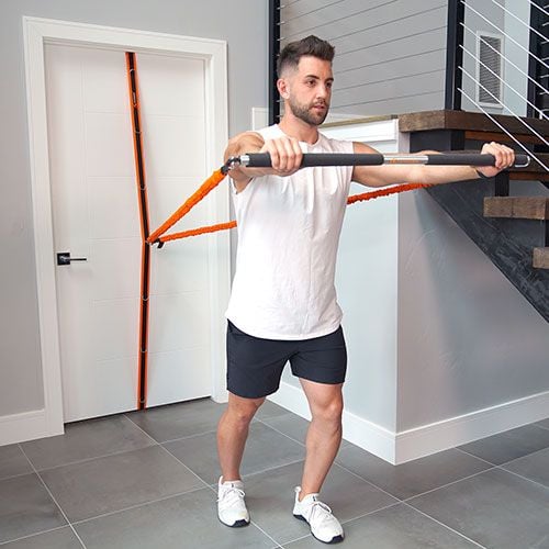 Male trainer uses spine strap