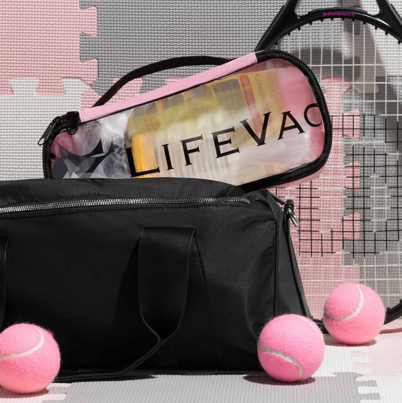 LifeVac Beside Tennis Racket, Balls, and Bag