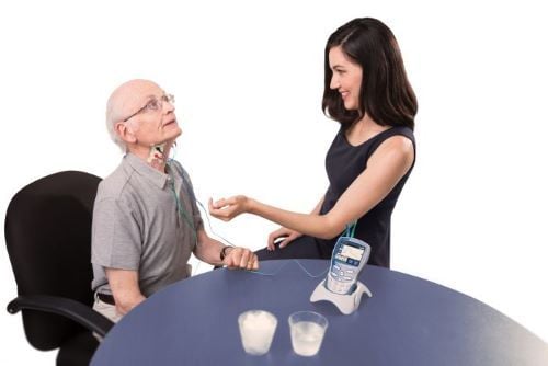 Professional using the unit on patients neck