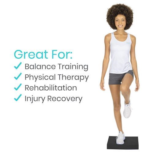 Woman stands confidently on one leg on the balance pad