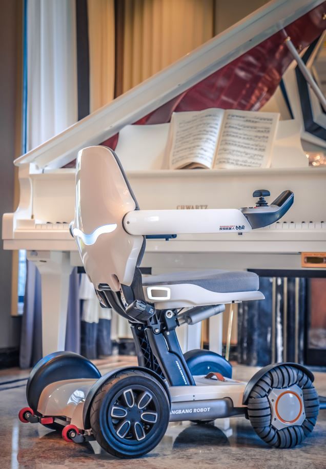 Robooter X40 Wheelchair Beside a Piano.