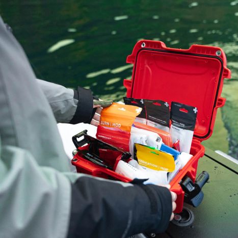 A boater opens the Boat Medic First Aid Kit and selects the Burn Mod package from inside