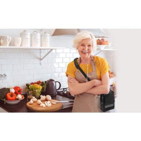 This lifestyle photo is of a woman cooking in her kitchen with a G5 unit in her carry bag.