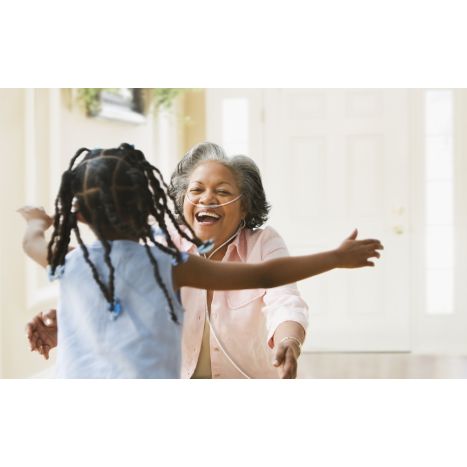This lifestyle photo is of a grandma wearing her G5 unit to have her hands free to hug her grandchild.