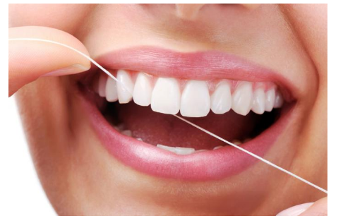 Woman Flossing Teeth