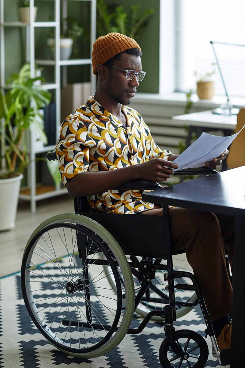 Man sitting at a desk in a wheelchair