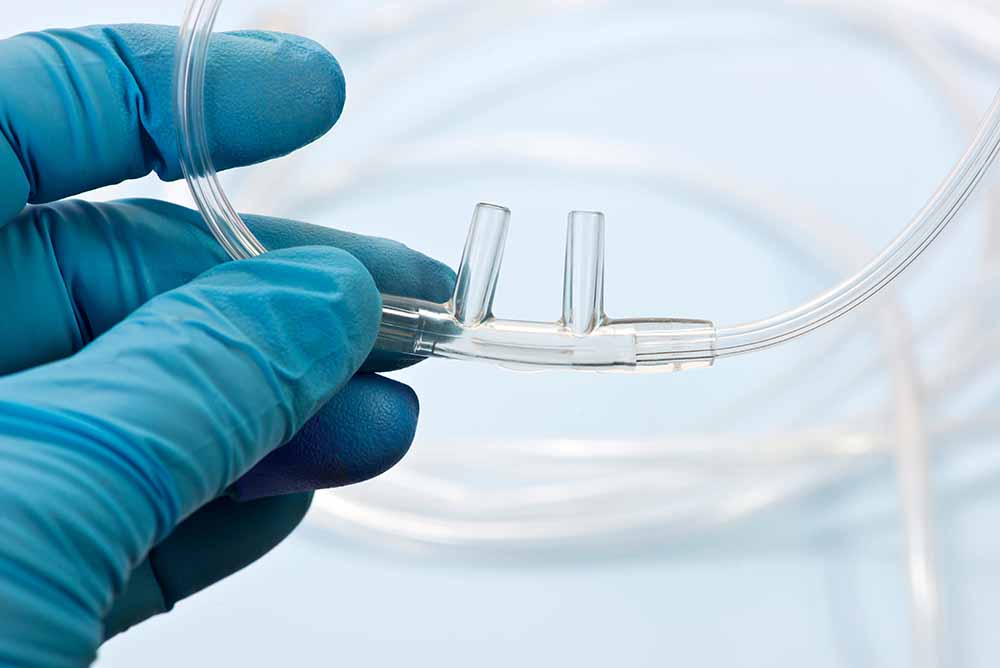 Nasal Cannula Held by a Gloved Hand