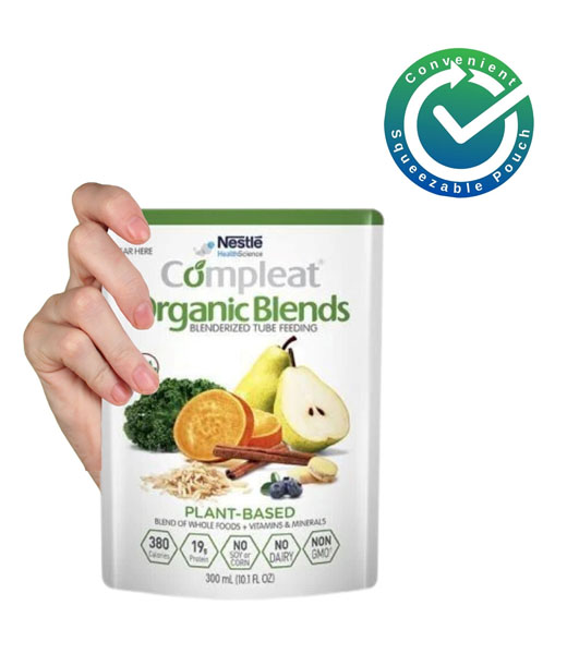 A hand holding a squeezable pouch of Compleat Organic Blends.