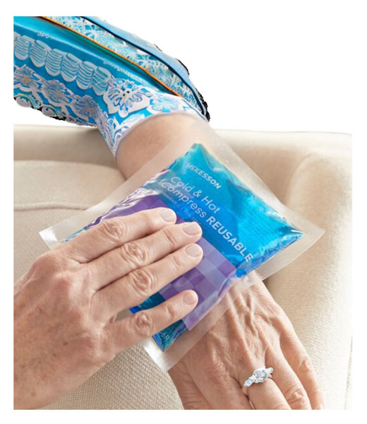 A patient using the hot and cold pack on her hand.