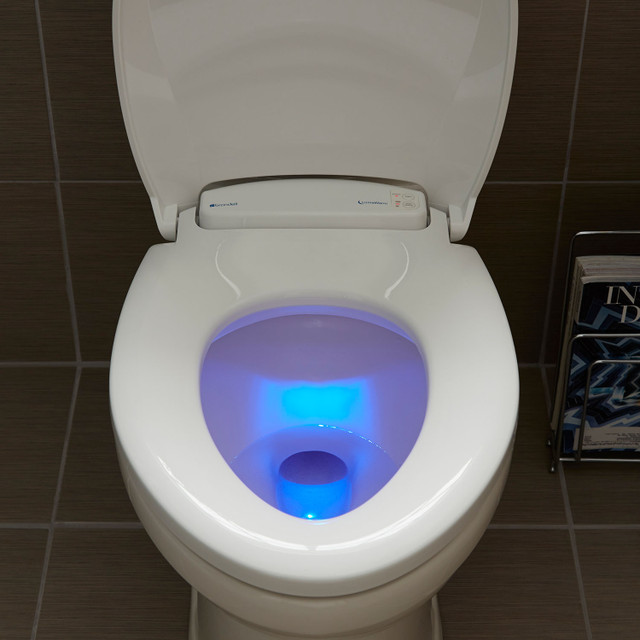 Toilet is illuminated with the LumaWarm's blue LED light