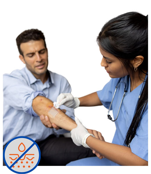 A medical professional removing a dressing from a patient's arm.