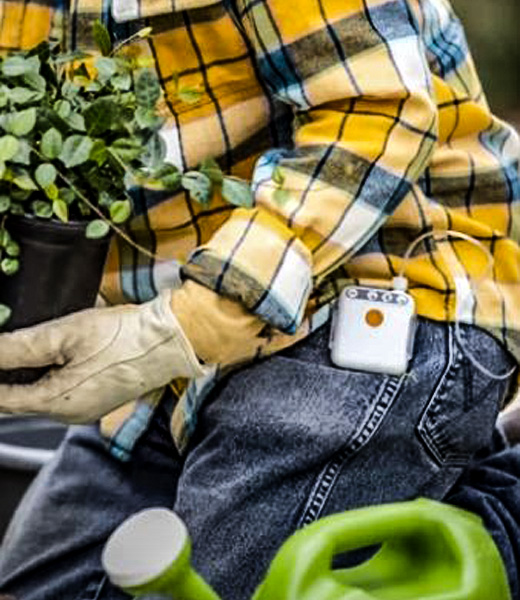 A person gardening while wearing their PICO 7 system.