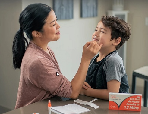iHealth COVID-19 Antigen Rapid Test being administered on boy