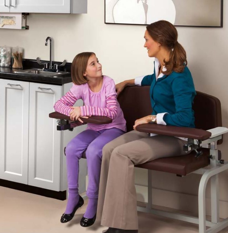 Mother and child sitting on bariatric blood drawing chair.