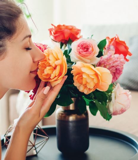 Woman Smelling Flowers