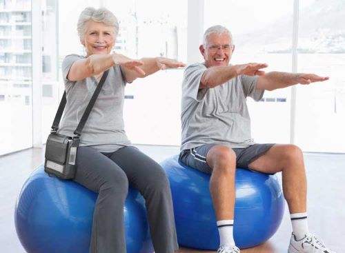 A senior uses the G5 during exercise on a stability ball